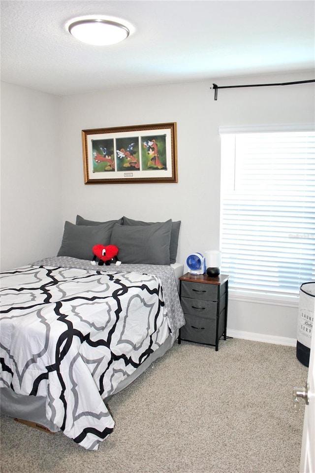 bedroom with carpet and baseboards