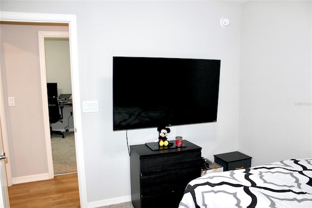 bedroom with baseboards and wood finished floors