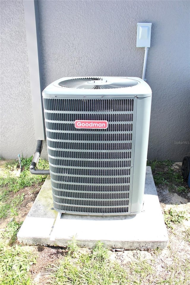 exterior details featuring cooling unit and stucco siding