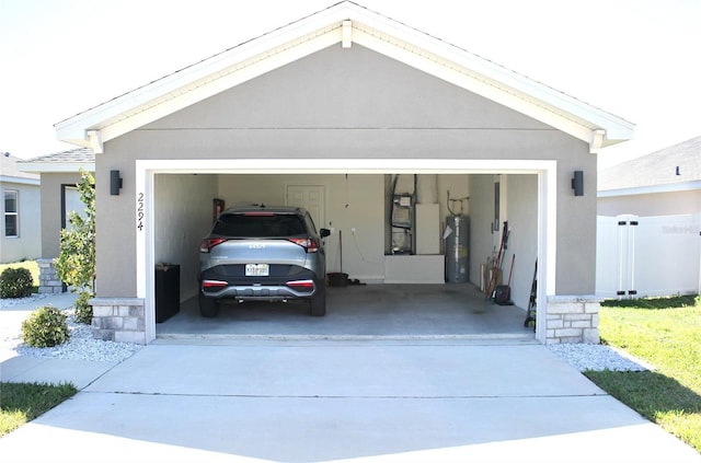 garage with water heater and driveway