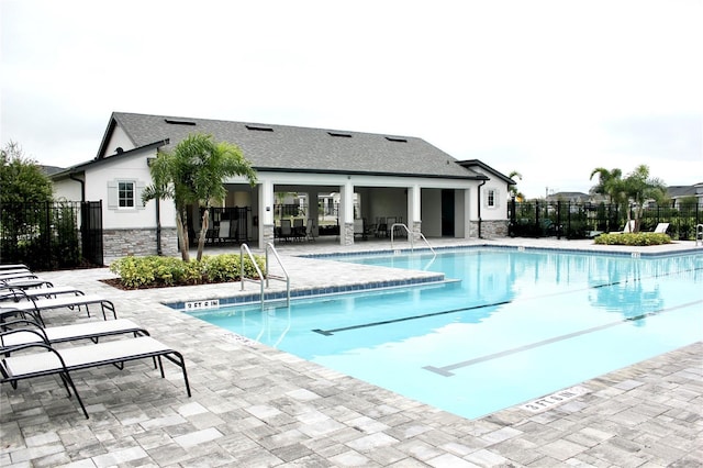 pool featuring a patio area and fence