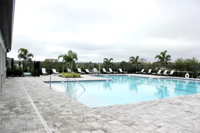 pool featuring a patio area and fence