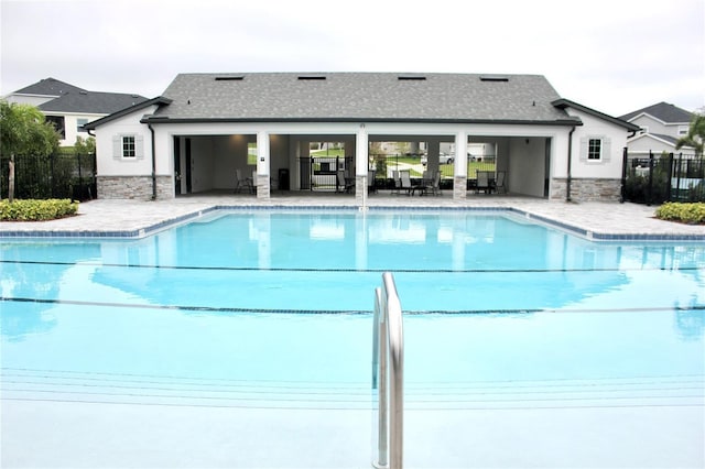 community pool featuring a patio area and fence