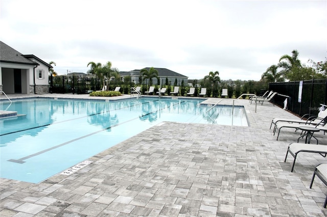 community pool featuring a patio area and fence