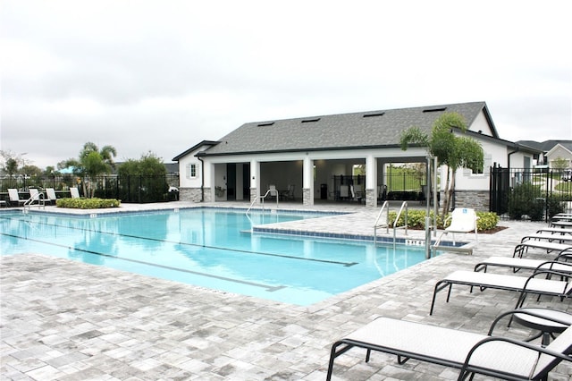 pool featuring a patio area and fence