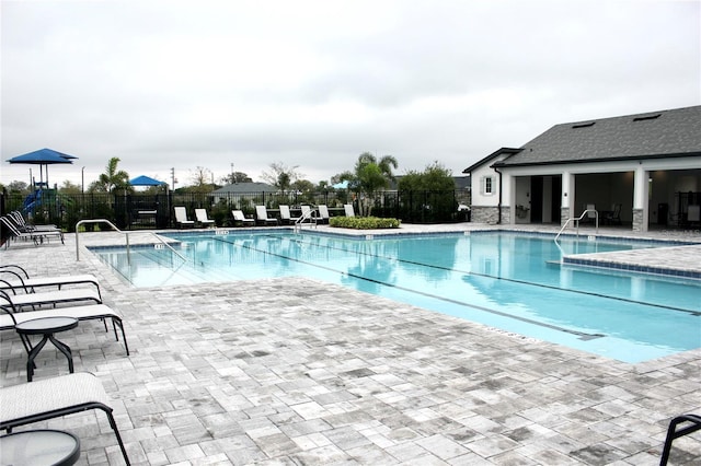 pool featuring a patio area and fence