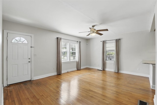 entrance foyer with a ceiling fan, light wood-type flooring, visible vents, and plenty of natural light