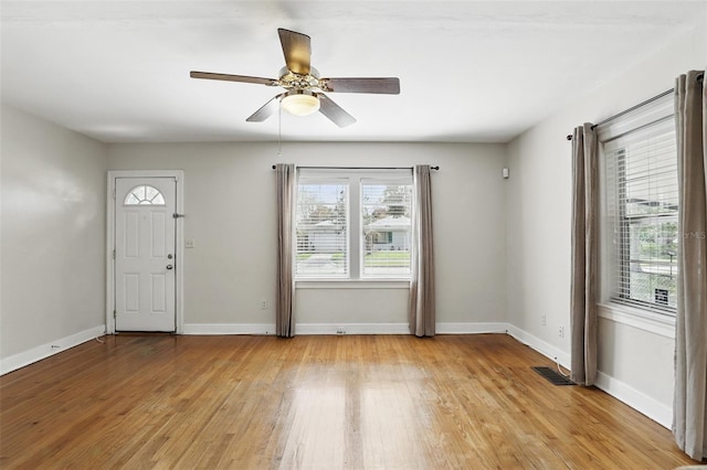 foyer with ceiling fan, light wood-type flooring, visible vents, and baseboards