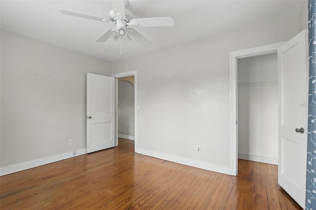 unfurnished bedroom with a ceiling fan, a closet, baseboards, and wood finished floors