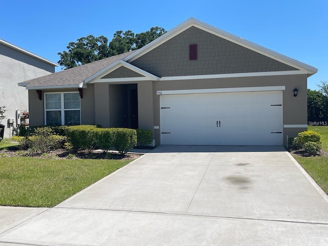 ranch-style home with a garage, concrete driveway, roof with shingles, and stucco siding