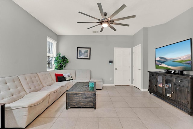 living room with light tile patterned floors, baseboards, visible vents, and a ceiling fan