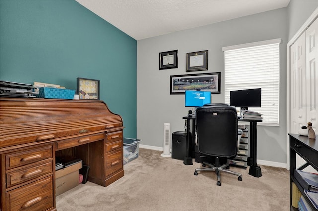 carpeted office featuring baseboards