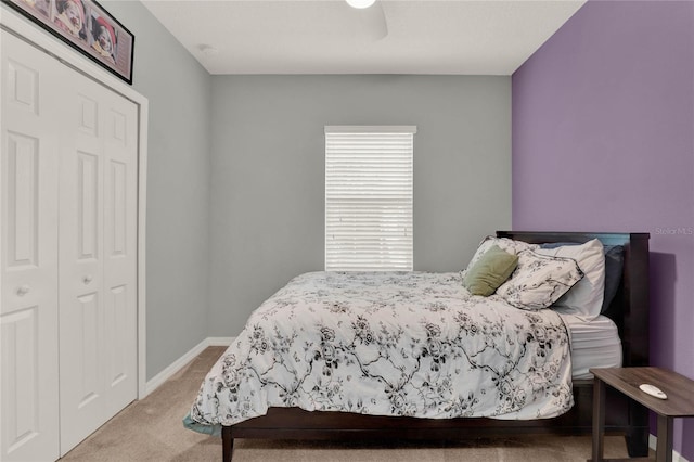 carpeted bedroom featuring a closet, a ceiling fan, and baseboards