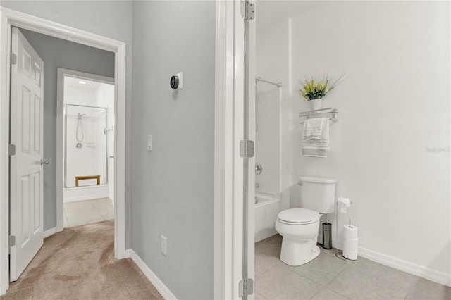 full bathroom featuring baseboards, tub / shower combination, toilet, and tile patterned floors