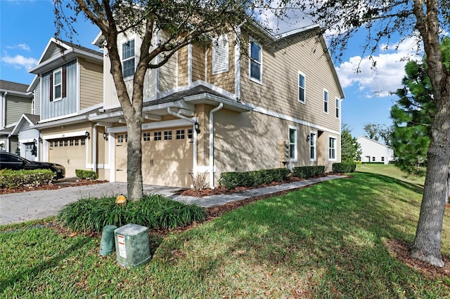 view of property exterior featuring driveway, a lawn, an attached garage, and stucco siding