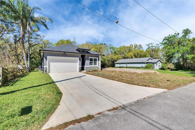 view of front of property with a garage, fence, concrete driveway, stucco siding, and a front lawn