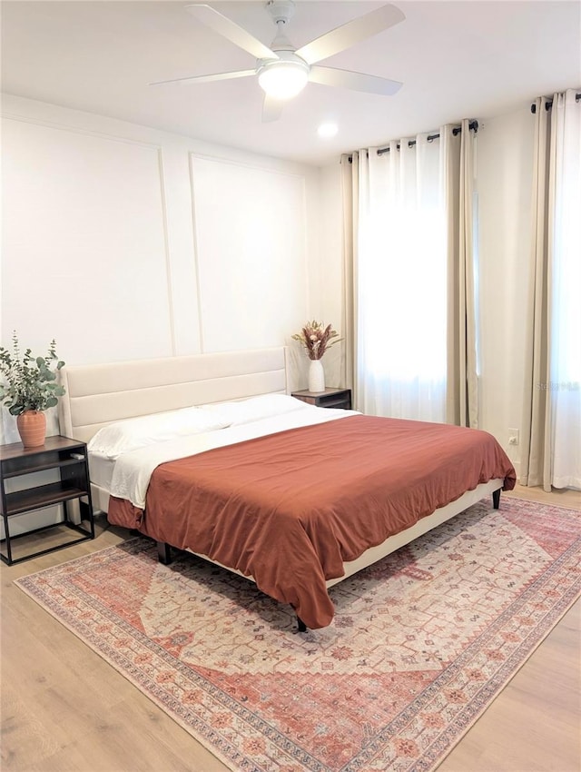 bedroom with a ceiling fan and wood finished floors