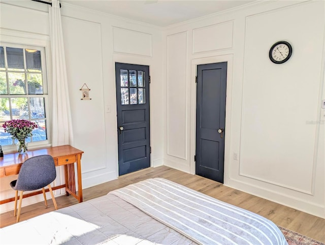 foyer with a healthy amount of sunlight, wood finished floors, and a decorative wall