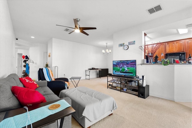 living room with ceiling fan, visible vents, and light colored carpet