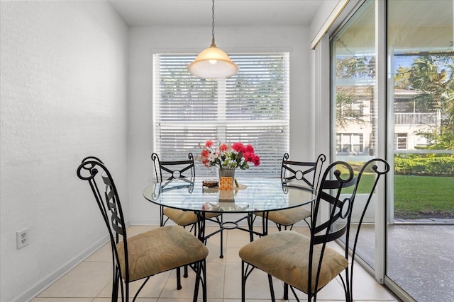 dining area with baseboards and light tile patterned floors