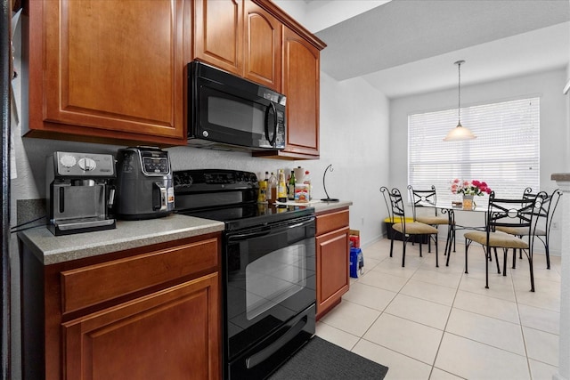 kitchen with brown cabinets, black appliances, light tile patterned floors, and pendant lighting