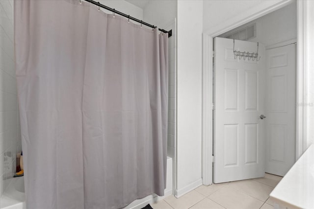 bathroom featuring shower / bath combo with shower curtain, visible vents, and tile patterned floors