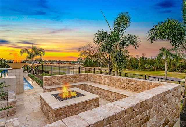 view of patio / terrace with an outdoor fire pit and a fenced backyard