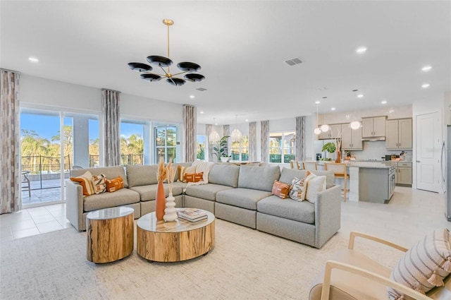 living area featuring an inviting chandelier, light tile patterned flooring, visible vents, and recessed lighting