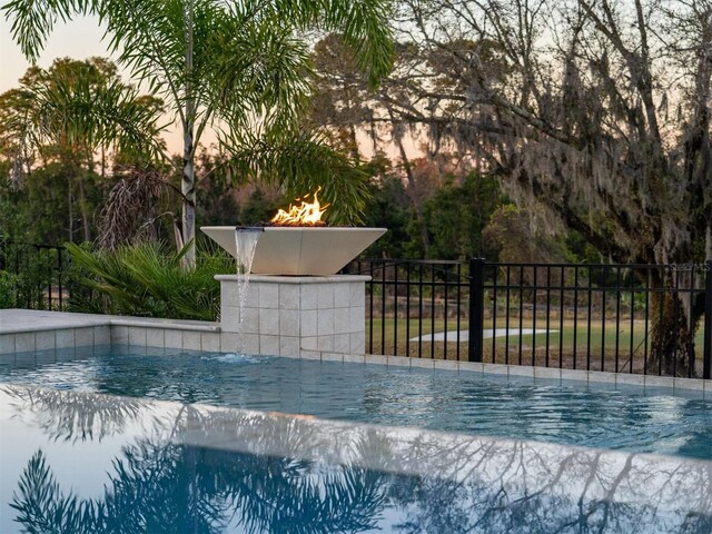 view of swimming pool featuring fence