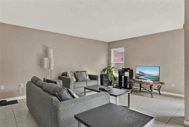 living room featuring baseboards and light tile patterned flooring