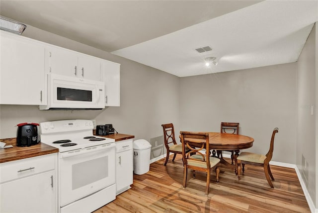 kitchen featuring visible vents, light wood-style floors, white cabinets, wood counters, and white appliances