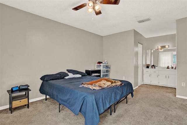 bedroom featuring baseboards, visible vents, light colored carpet, ceiling fan, and a textured ceiling