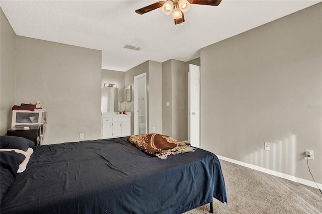 bedroom featuring carpet floors, visible vents, a ceiling fan, connected bathroom, and baseboards