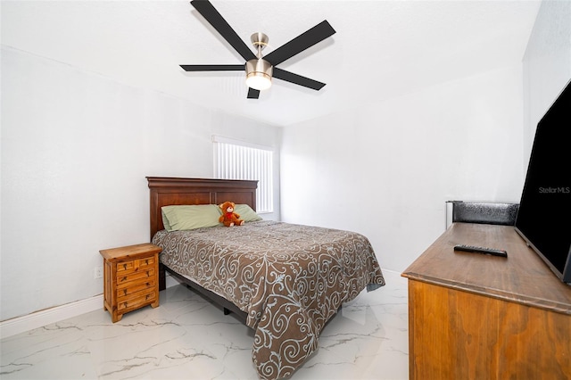 bedroom with marble finish floor, a ceiling fan, and baseboards