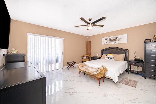 bedroom featuring marble finish floor and a ceiling fan