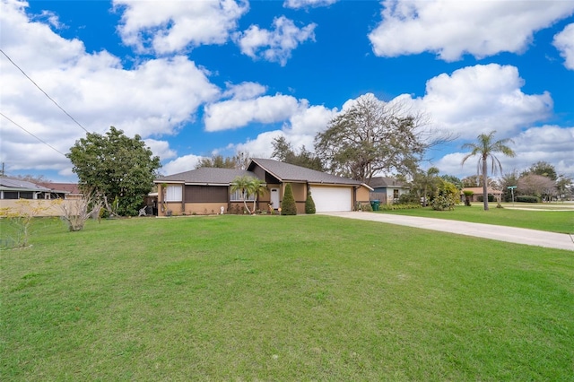 ranch-style home with a garage, concrete driveway, and a front yard