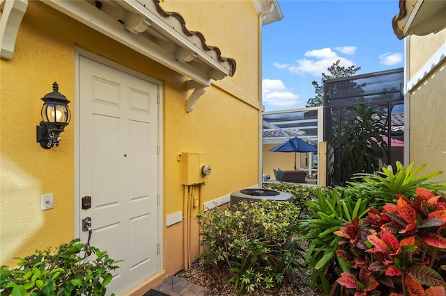 doorway to property with stucco siding