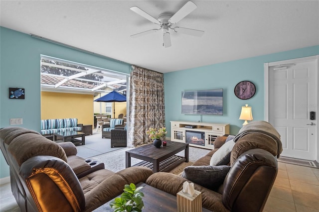 living area featuring ceiling fan and tile patterned flooring