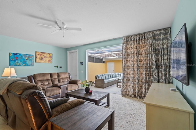 carpeted living room featuring ceiling fan