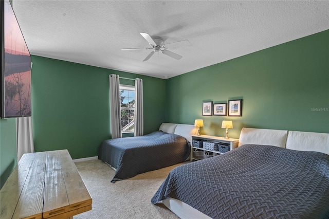 bedroom featuring a textured ceiling, carpet floors, a ceiling fan, and baseboards