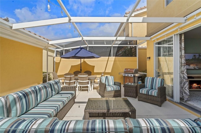 view of patio featuring a lanai, outdoor dining area, grilling area, and an outdoor living space