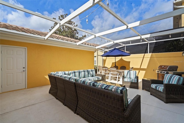 view of patio featuring area for grilling, glass enclosure, and outdoor lounge area