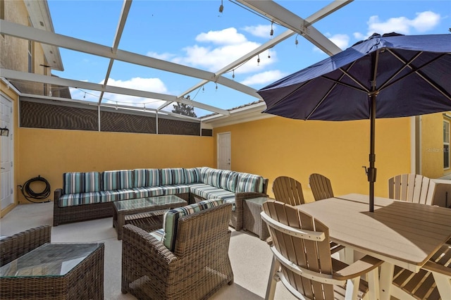 view of patio / terrace with outdoor dining space, glass enclosure, and an outdoor living space