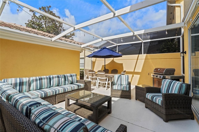 view of patio / terrace with glass enclosure, grilling area, and outdoor lounge area