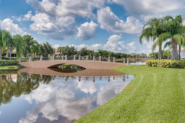 view of property's community with a water view and a yard