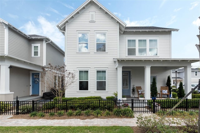 view of front of house with a fenced front yard and a patio area