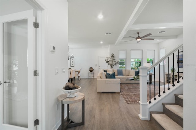 living area with stairs, recessed lighting, visible vents, and wood finished floors