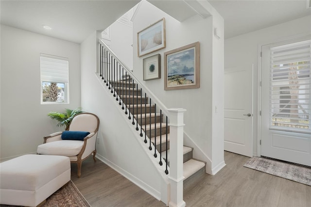 entrance foyer featuring stairway, wood finished floors, and baseboards