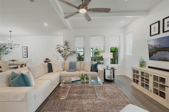 living room with ceiling fan with notable chandelier, dark wood finished floors, beam ceiling, and recessed lighting