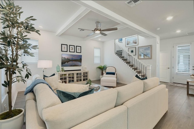 living area with recessed lighting, visible vents, wood finished floors, beamed ceiling, and stairs